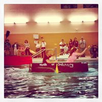 Students participating in a boat race in a pool