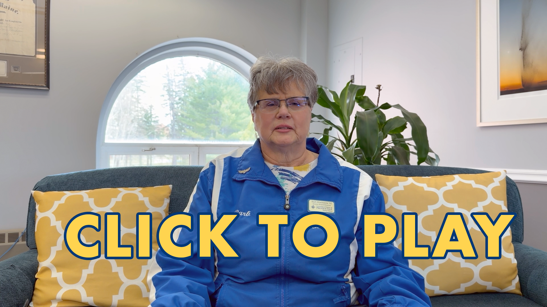 A photo of Barb Blackstone, president of the alumni association with the words "click to play" across the bottom.