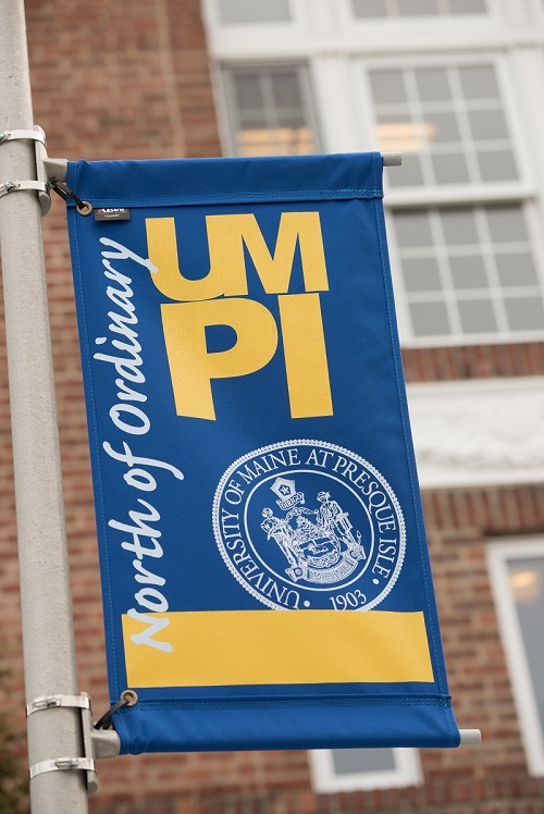 Photo of UMPI banner outside a campus building.