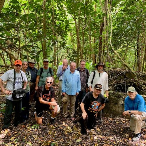 Photo of retired UMPI professor Anderson Giles, far right, leading a tour of the island of Peleliu with a group including veterans and documentary film director Tim Gray, far left.