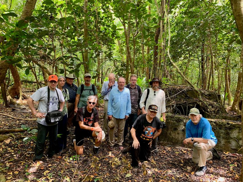 Photo of retired UMPI professor Anderson Giles, far right, leading a tour of the island of Peleliu with a group including veterans and documentary film director Tim Gray, far left.