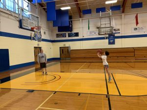 Naomi playing basketball with Dan