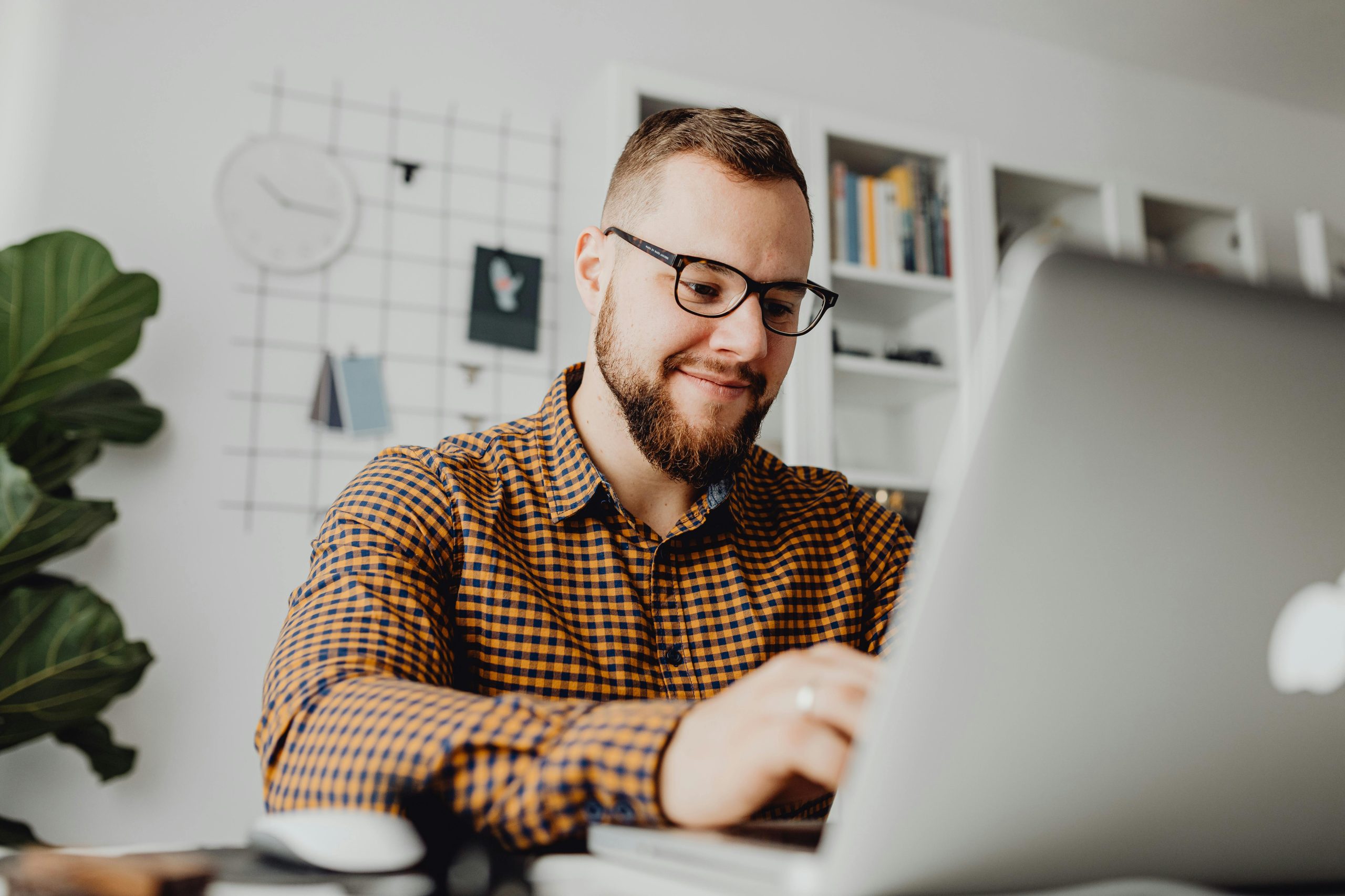 A photo of a man working on his laptop.