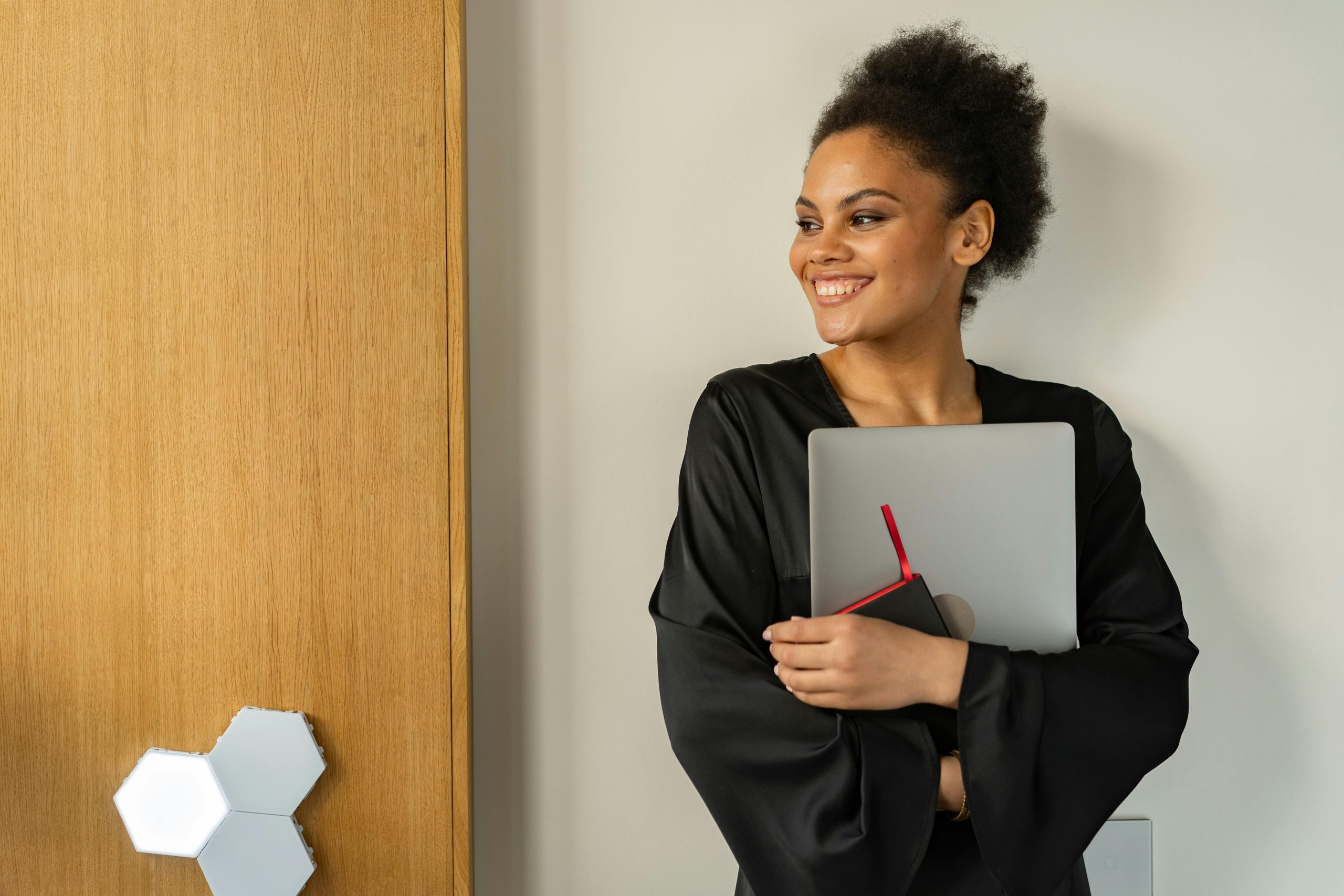 A photo of a woman holding a laptop.