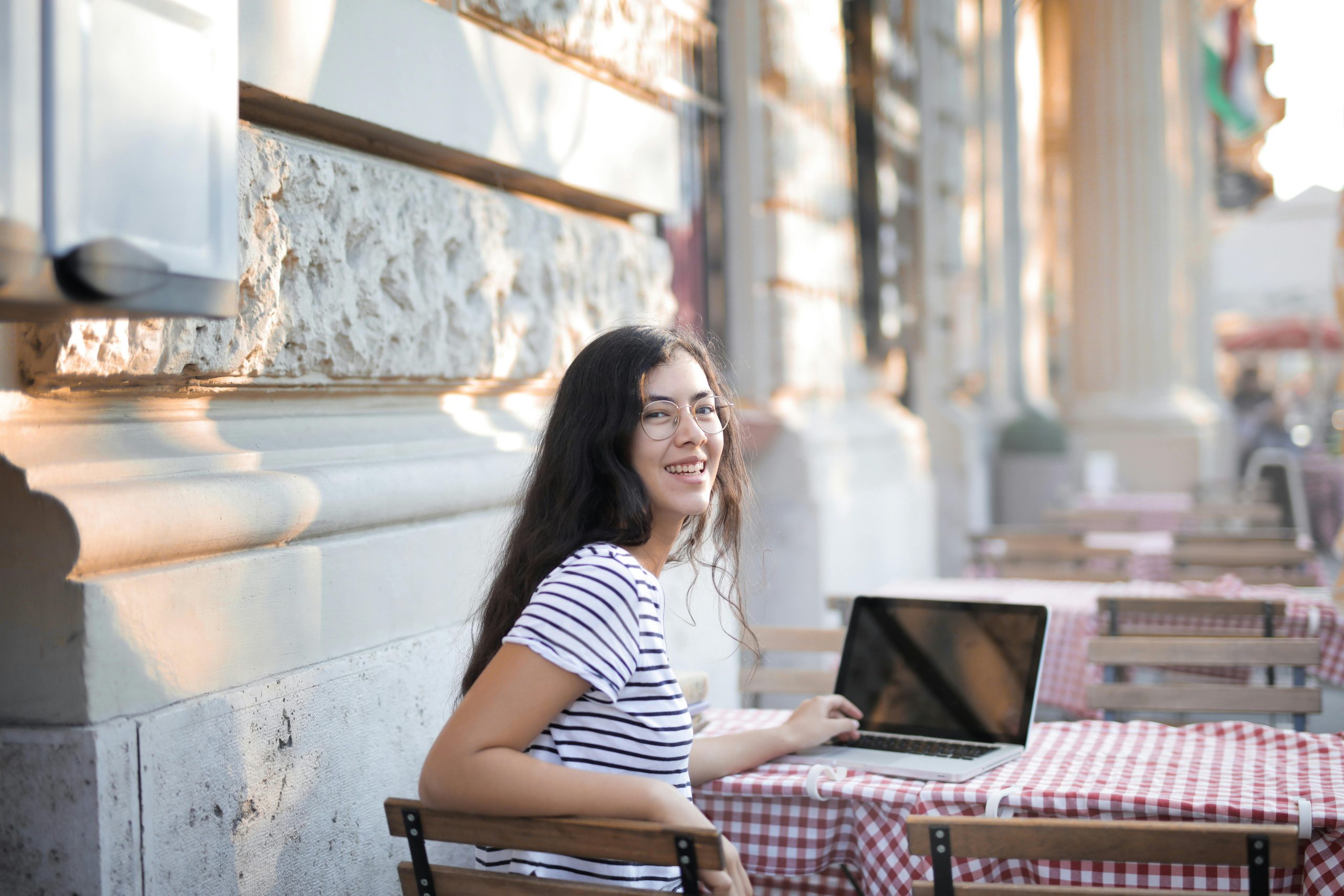 A photo of a woman working on a laptop.