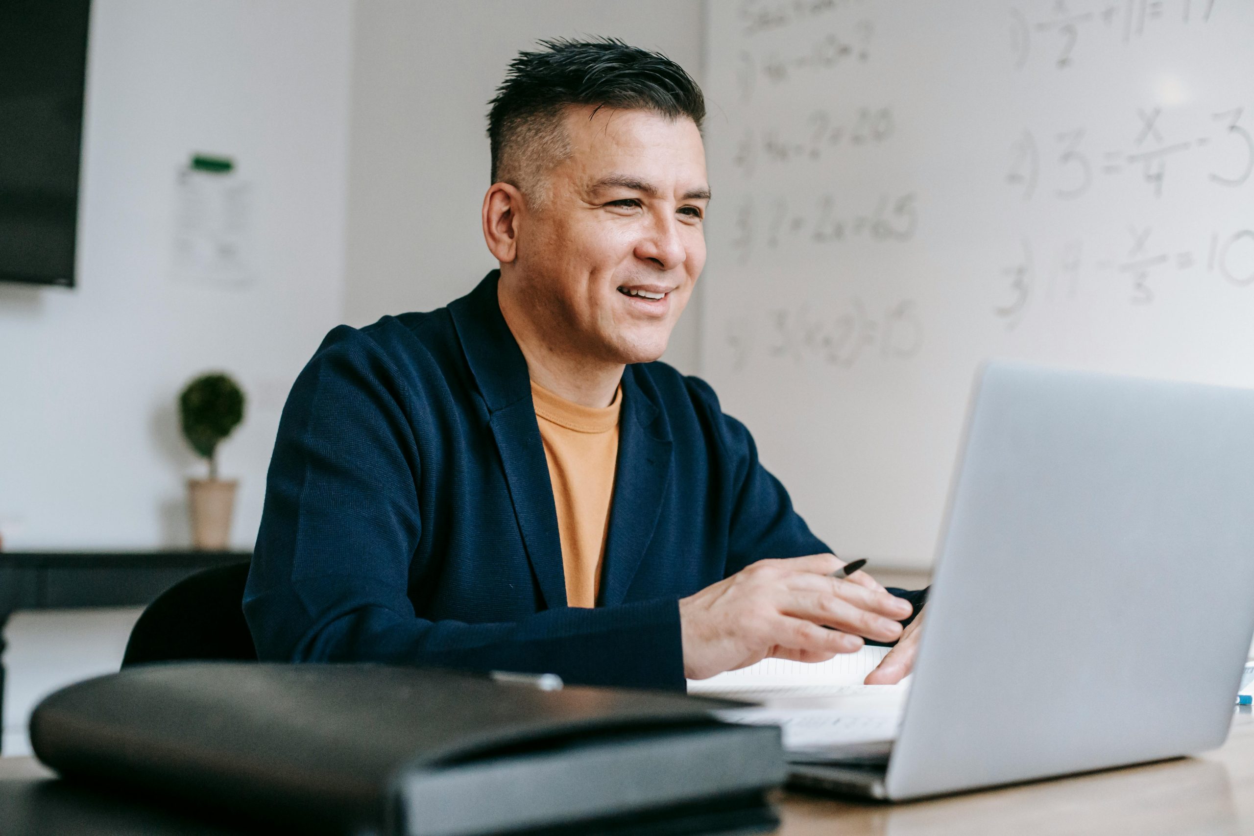 A photo of a man working on his laptop.