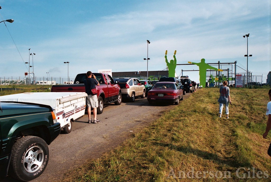 long line of cars at the entry gate