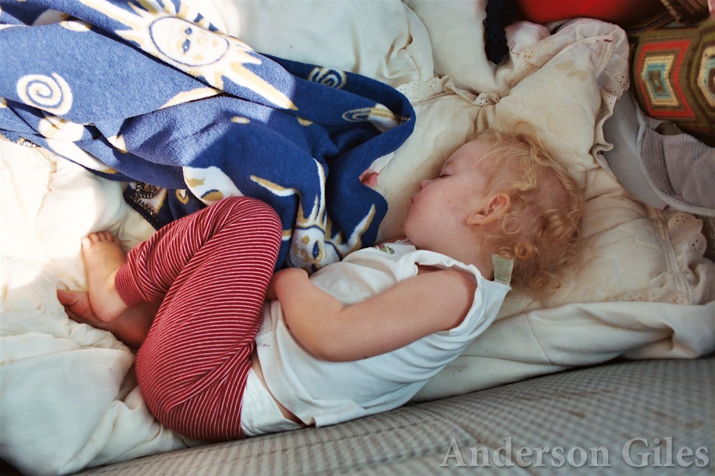 child curled up and sleeping
