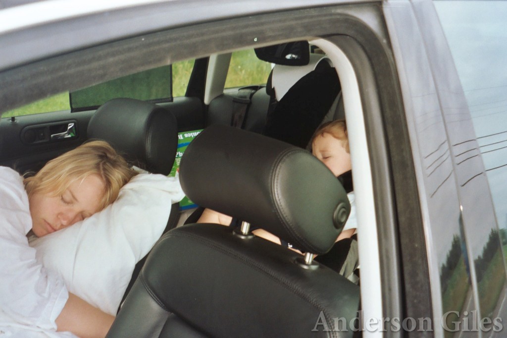 fan and child sleeping in their car