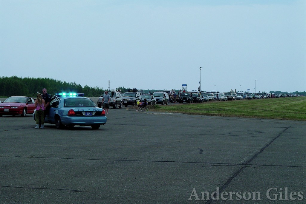 police car with lights on, directing traffic