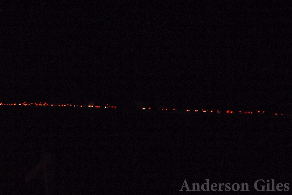 horizontal line of red lights in the distance at night